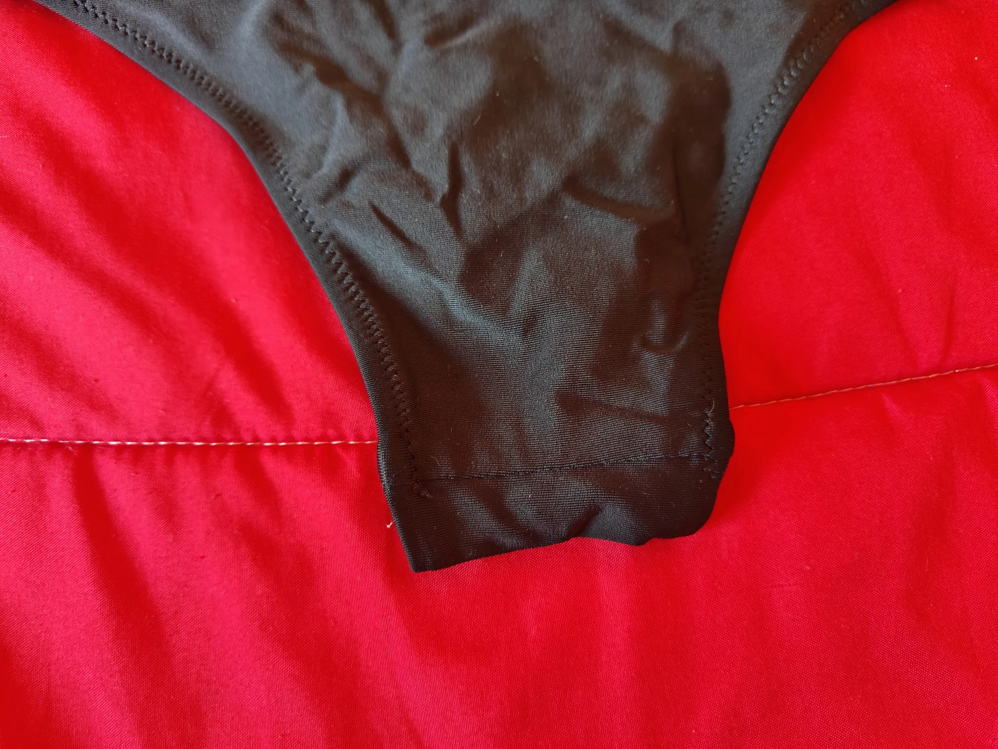 Black bikini-style briefs with a modern design and strap detail. – photo 3